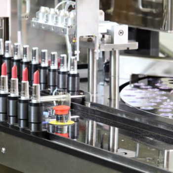 A lipstick packaging machine in a cosmetics factory.